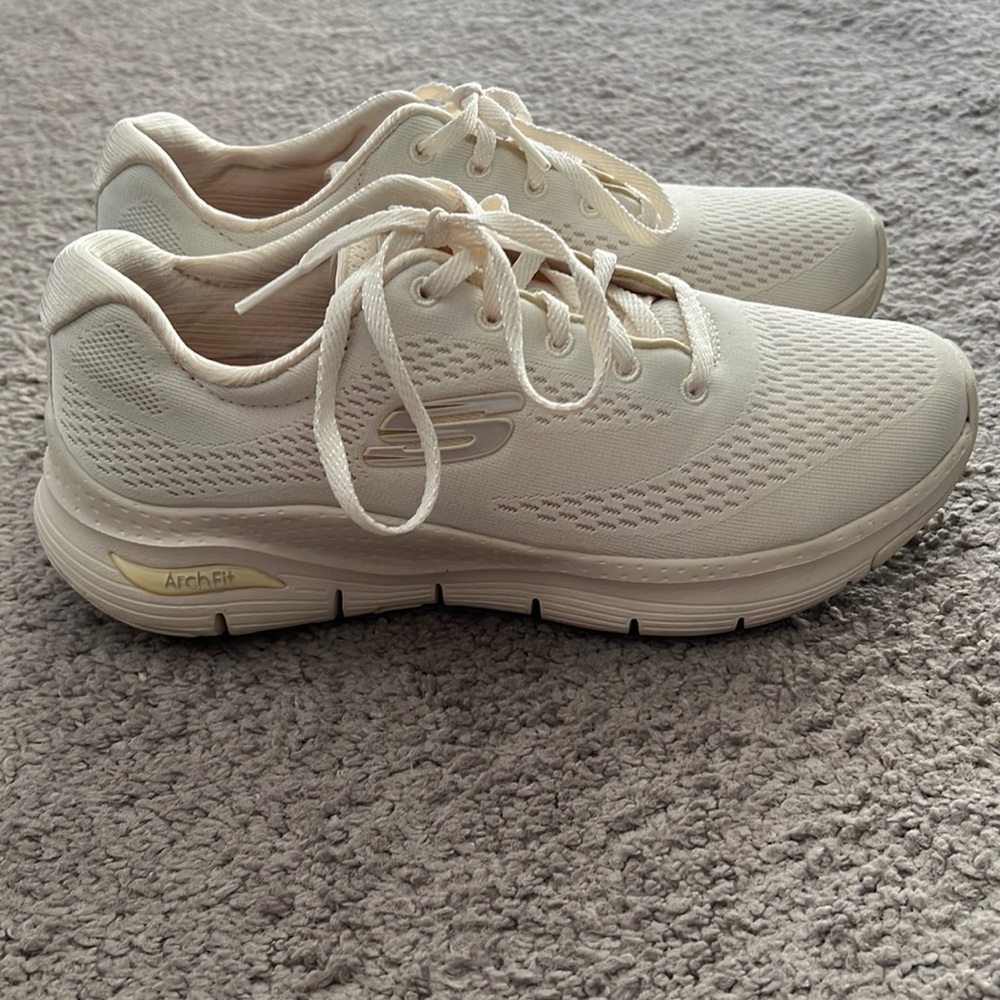Cream colored skecher arch fit sneaker